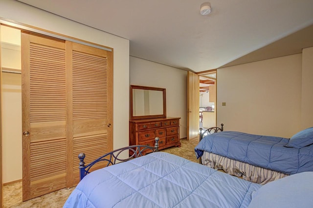 bedroom featuring light carpet and a closet