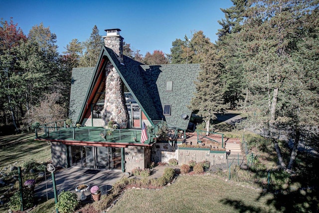 rear view of house with a patio area, a yard, and a sunroom