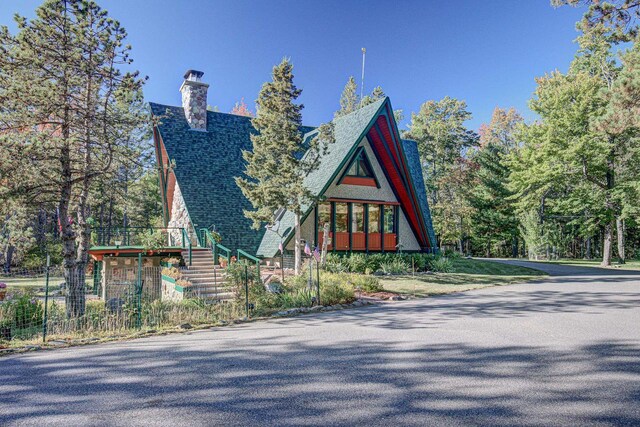 6147 County Rd E, Phelps, WI 54554 - exterior space featuring a chimney, roof with shingles, and stairway