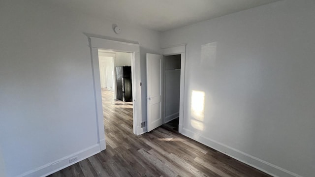 empty room with dark hardwood / wood-style floors