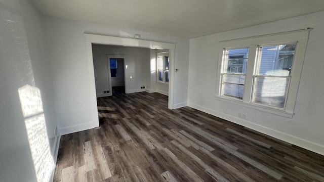 unfurnished room with dark wood-type flooring