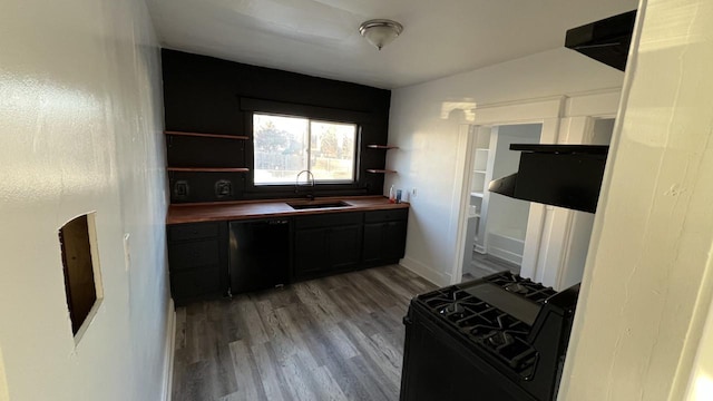 kitchen featuring wooden counters, sink, black appliances, and wood-type flooring