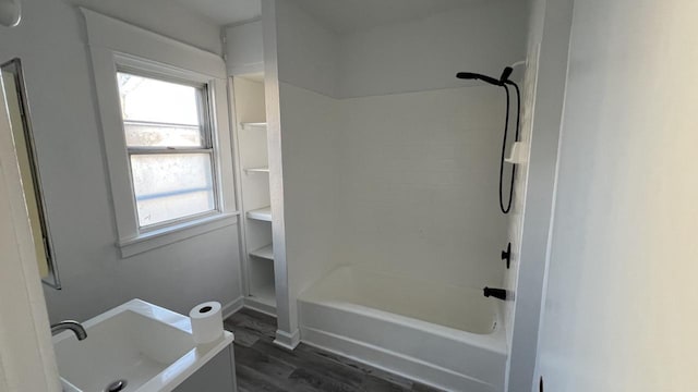 bathroom featuring hardwood / wood-style floors and bathtub / shower combination