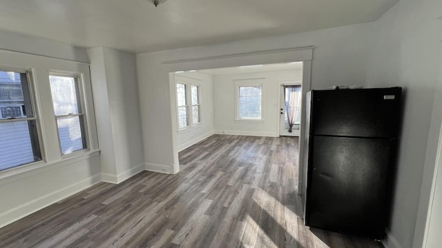 kitchen featuring hardwood / wood-style flooring and black refrigerator