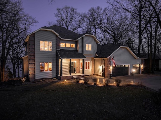 1516 E Orchard Beach Ln, Rice Lake, WI 54868 - traditional home featuring a porch, an attached garage, concrete driveway, and roof with shingles