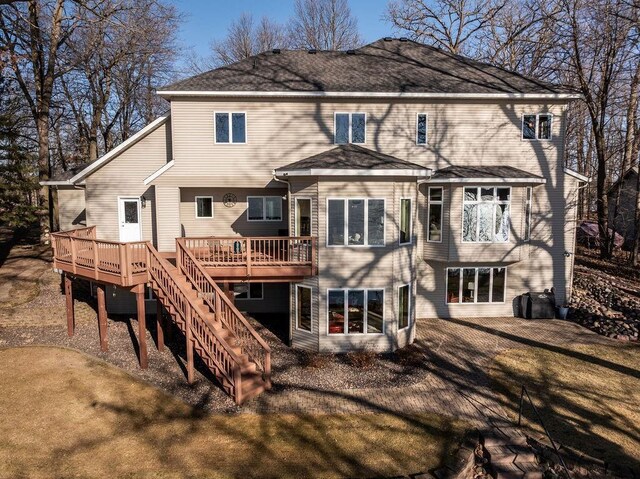1516 E Orchard Beach Ln, Rice Lake, WI 54868 - rear view of property with a wooden deck and stairway