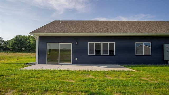 rear view of property with a yard and a patio area