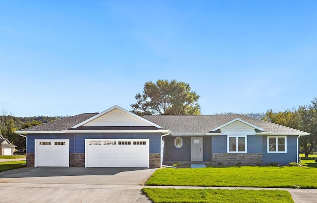 ranch-style house featuring a front yard and a garage