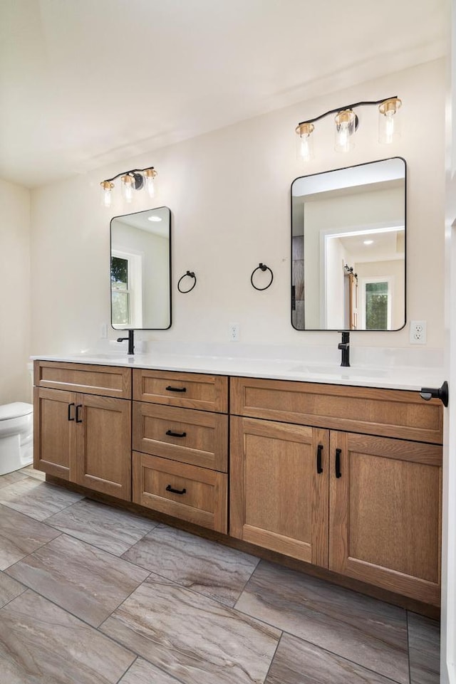 bathroom with toilet and vanity