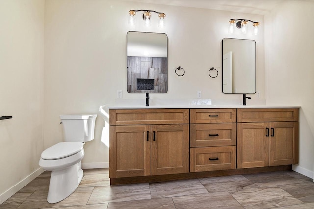 bathroom with toilet and vanity