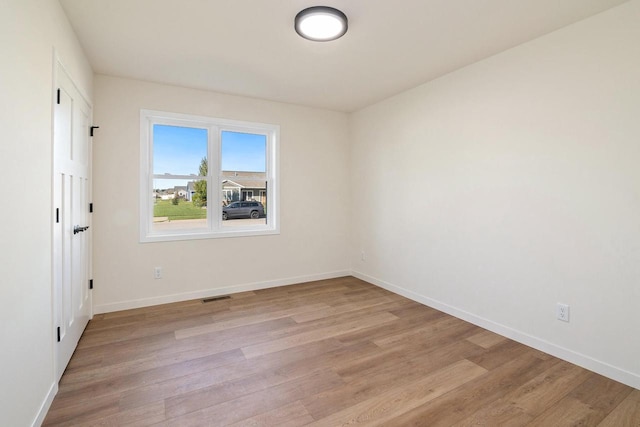 spare room featuring light hardwood / wood-style floors