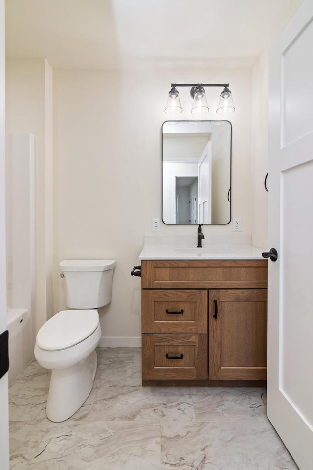 bathroom featuring toilet and vanity