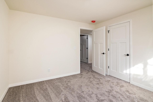 unfurnished bedroom featuring light colored carpet