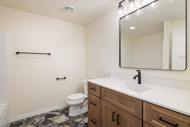 bathroom featuring toilet and vanity