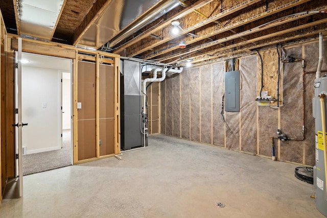 basement featuring heating unit, electric water heater, and electric panel