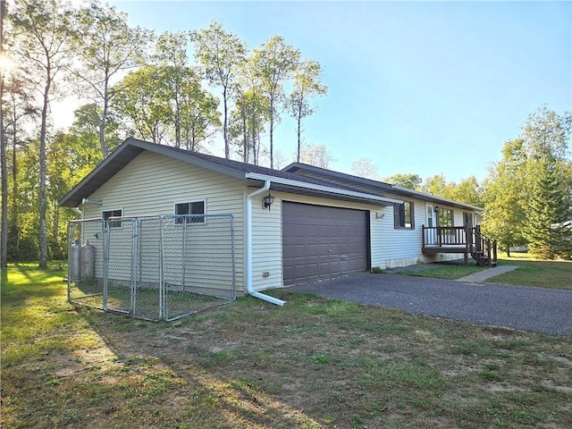 view of side of property with a garage and a lawn