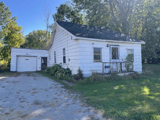 view of front of home with a front yard and a garage