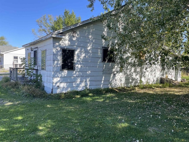 view of side of home featuring a lawn