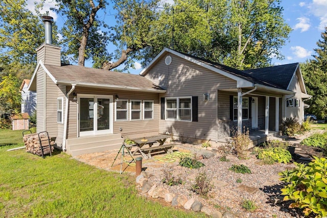 rear view of house with a yard