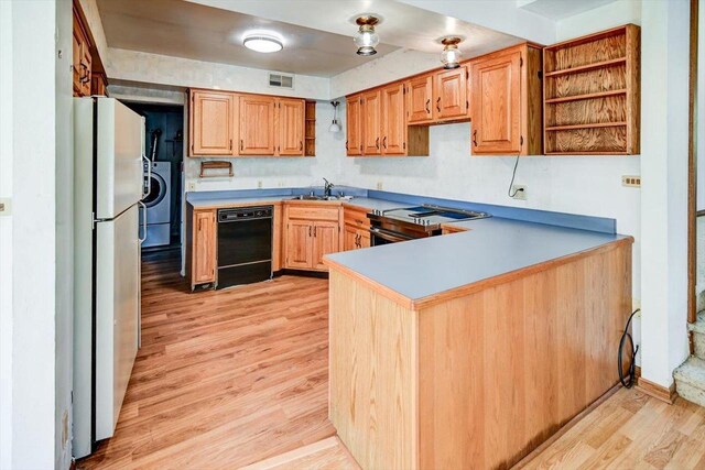 kitchen with dishwasher, light hardwood / wood-style floors, washer / clothes dryer, kitchen peninsula, and white fridge