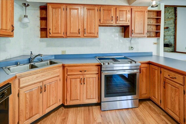 kitchen featuring stainless steel range with electric stovetop, dishwasher, pendant lighting, light hardwood / wood-style flooring, and sink