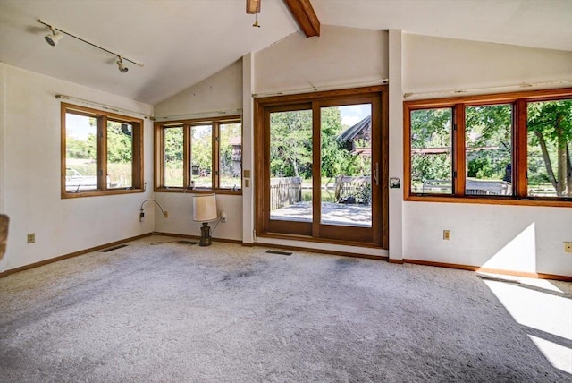 carpeted empty room featuring lofted ceiling with beams