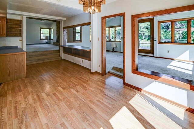2809 Dewey Ct, Middleton, WI 53562 - unfurnished dining area featuring light wood finished floors, baseboards, and a chandelier