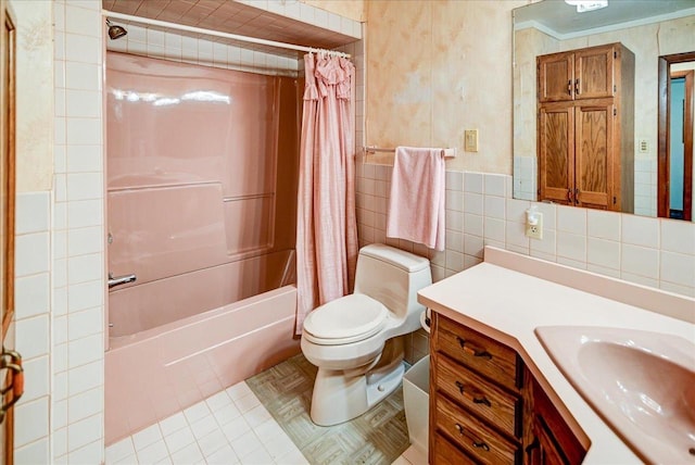 full bathroom with vanity, shower / bath combo with shower curtain, tile patterned floors, tile walls, and toilet