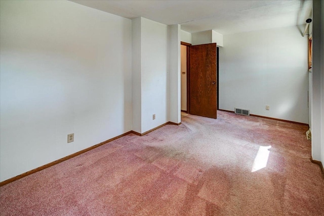 spare room featuring light colored carpet