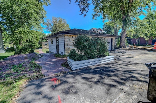 view of side of home featuring a garage