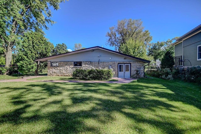 rear view of property featuring a yard