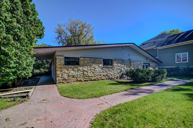 2809 Dewey Ct, Middleton, WI 53562 - view of side of home featuring stone siding and a yard