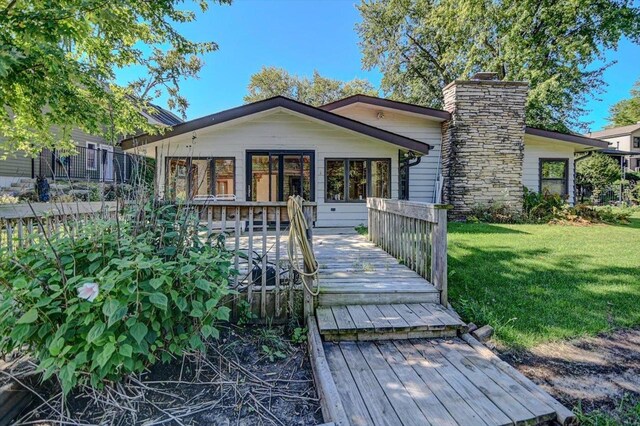 view of front of home with a front yard and a deck