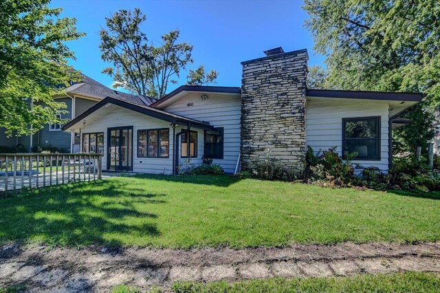 2809 Dewey Ct, Middleton, WI 53562 - rear view of house with a chimney and a yard