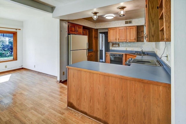 kitchen featuring range, backsplash, black dishwasher, kitchen peninsula, and light hardwood / wood-style flooring