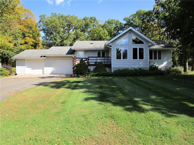 ranch-style house with a garage, a wooden deck, and a front yard