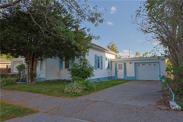 view of front of property with a front yard and a garage