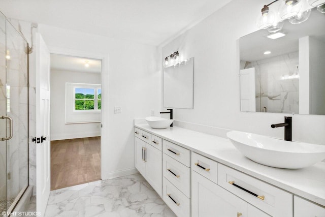 bathroom featuring walk in shower, vanity, and hardwood / wood-style flooring