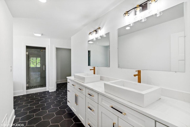 bathroom with tile patterned flooring, a shower with shower door, and vanity