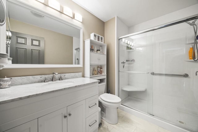 bathroom featuring walk in shower, vanity, and toilet