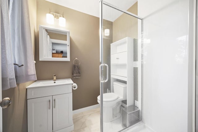 bathroom with vanity, toilet, and a shower with door