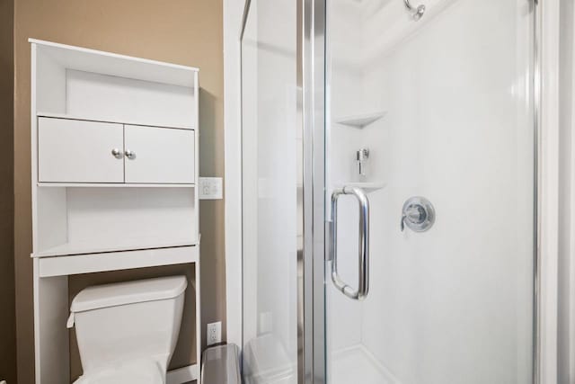 bathroom featuring walk in shower and toilet