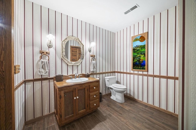 bathroom featuring hardwood / wood-style flooring, vanity, and toilet