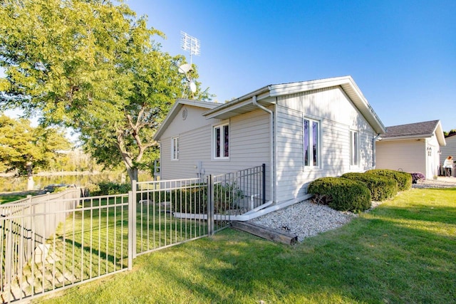 view of side of home with a yard