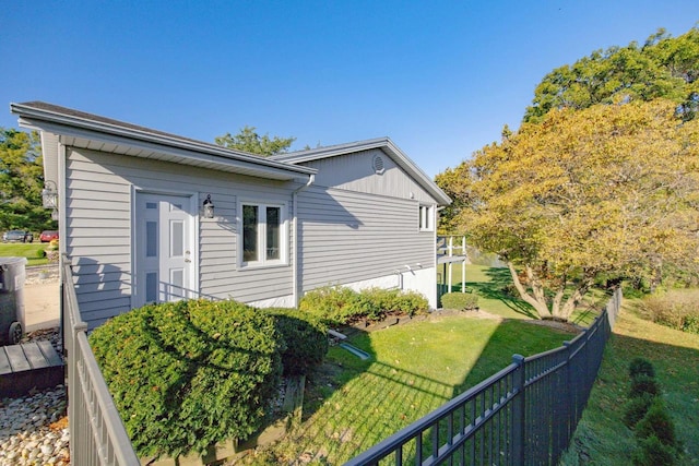 view of side of home with a lawn