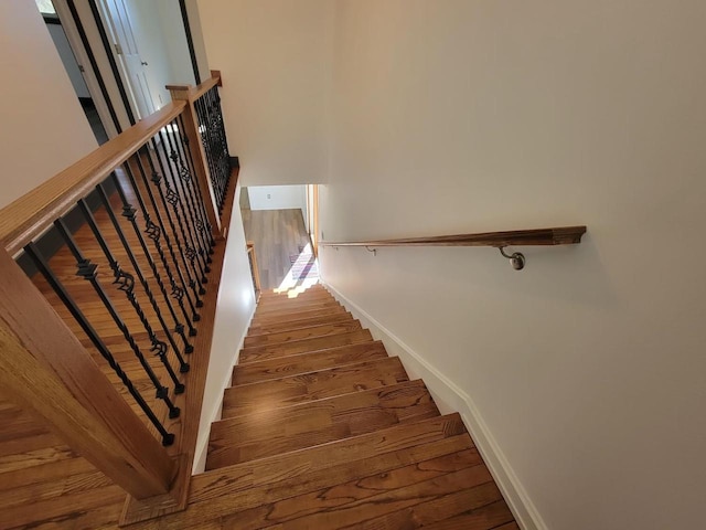 stairs with wood-type flooring