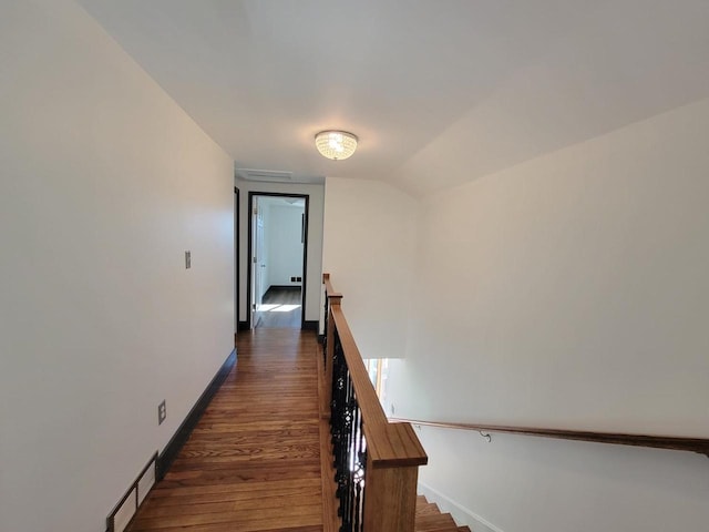 hall with lofted ceiling and dark hardwood / wood-style flooring