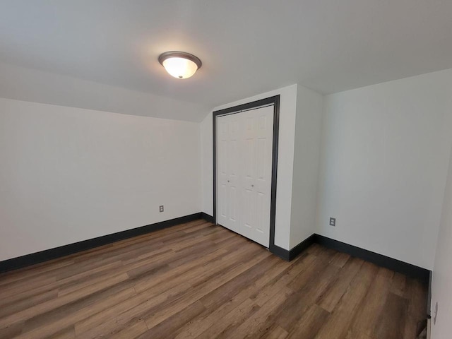 bonus room featuring dark wood-type flooring