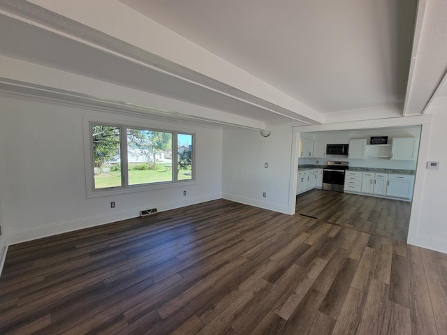 unfurnished living room with dark hardwood / wood-style floors and beam ceiling