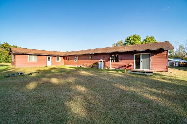 back of house with a lawn